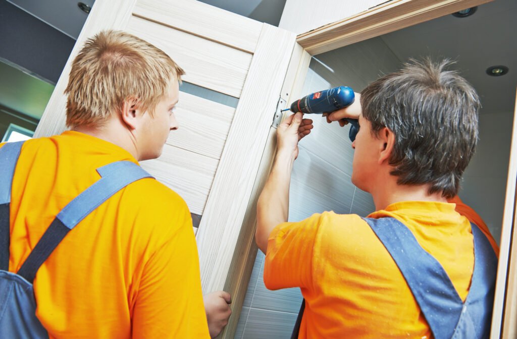 Two male workers carpenters at internal door installation